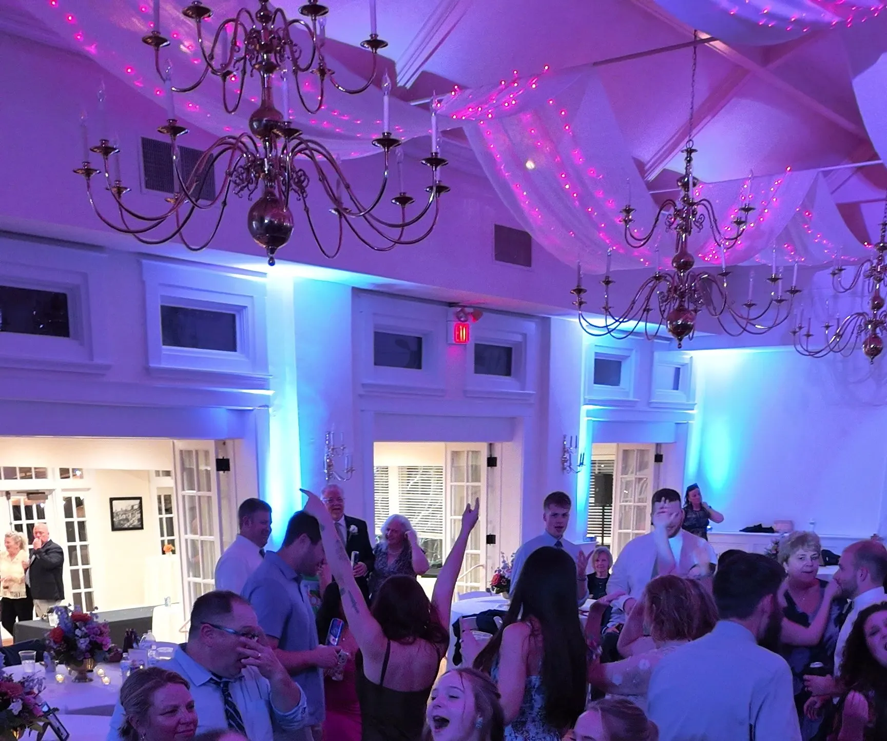 Hands up under the chandeliers